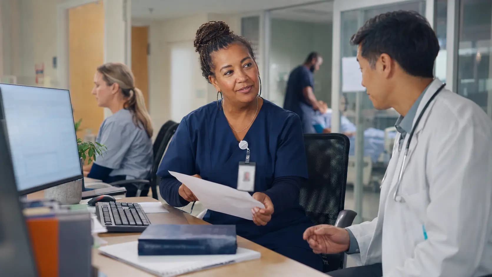 Medical coder and clinician resolving documentation together