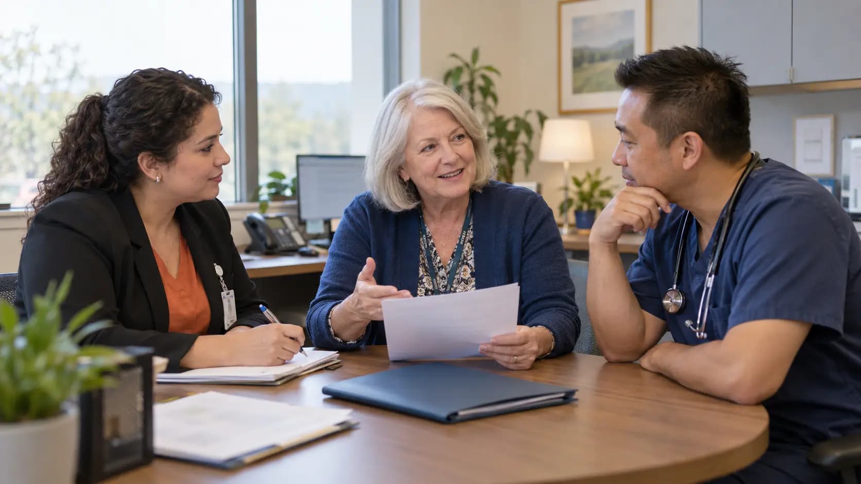 Practice manager and clinician reviewing payer requirements with a specialist