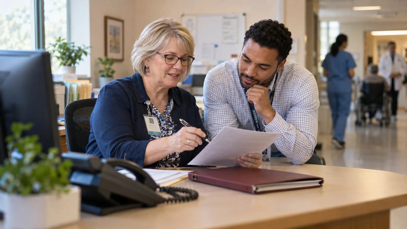 Reimbursement analyst and revenue manager reviewing a payment variance