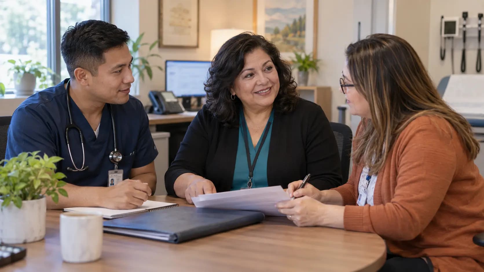 Practice manager and clinician reviewing payer requirements with a specialist