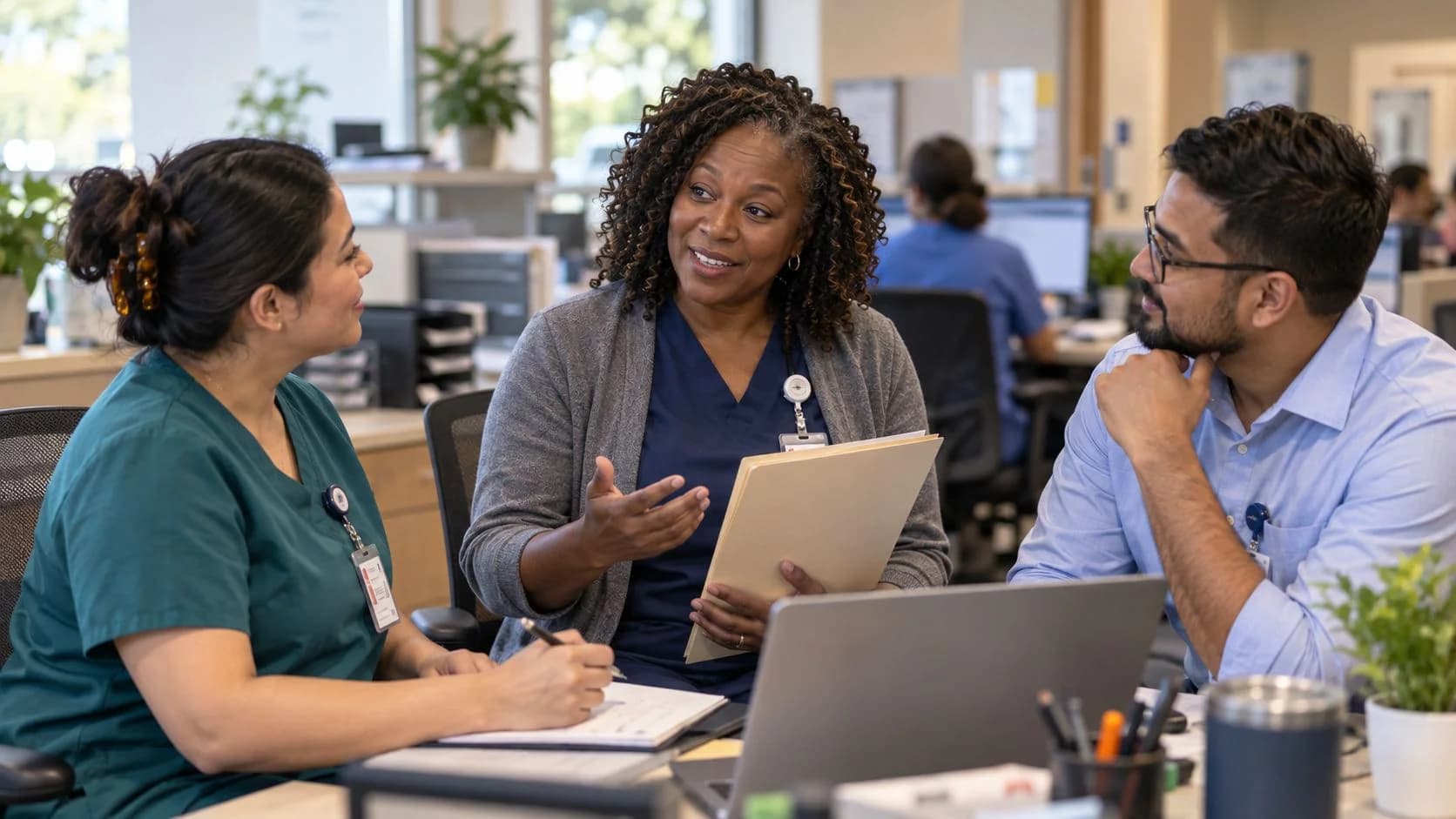 Revenue-cycle educator discussing a workflow with medical-office colleagues