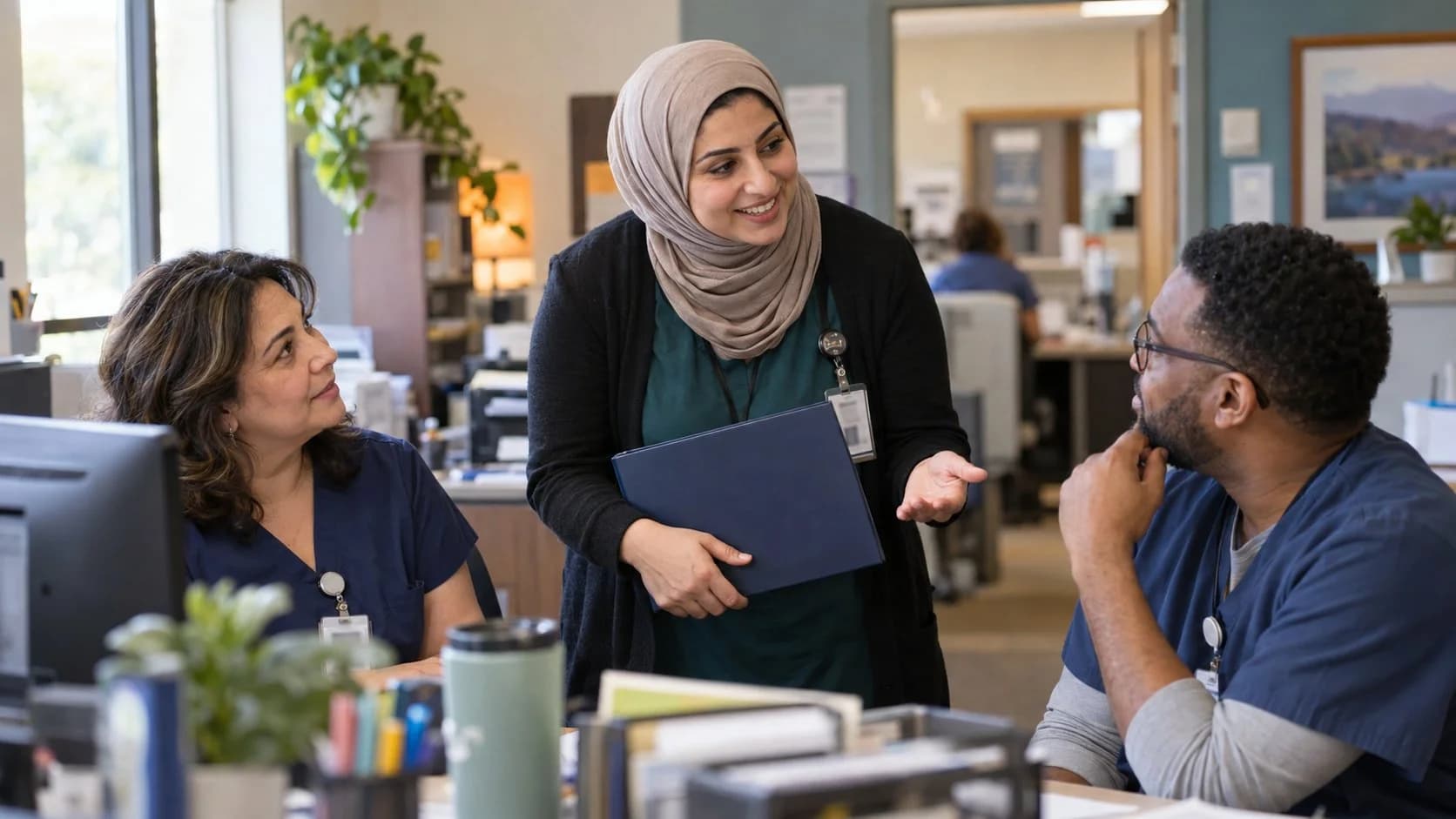 Revenue-cycle educator discussing a workflow with medical-office colleagues