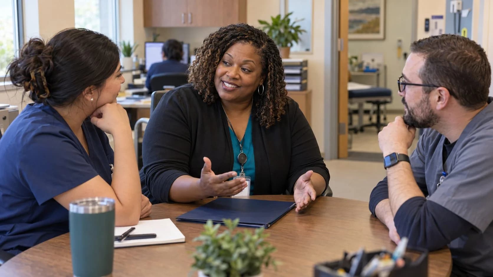 Revenue-cycle educator discussing a workflow with medical-office colleagues