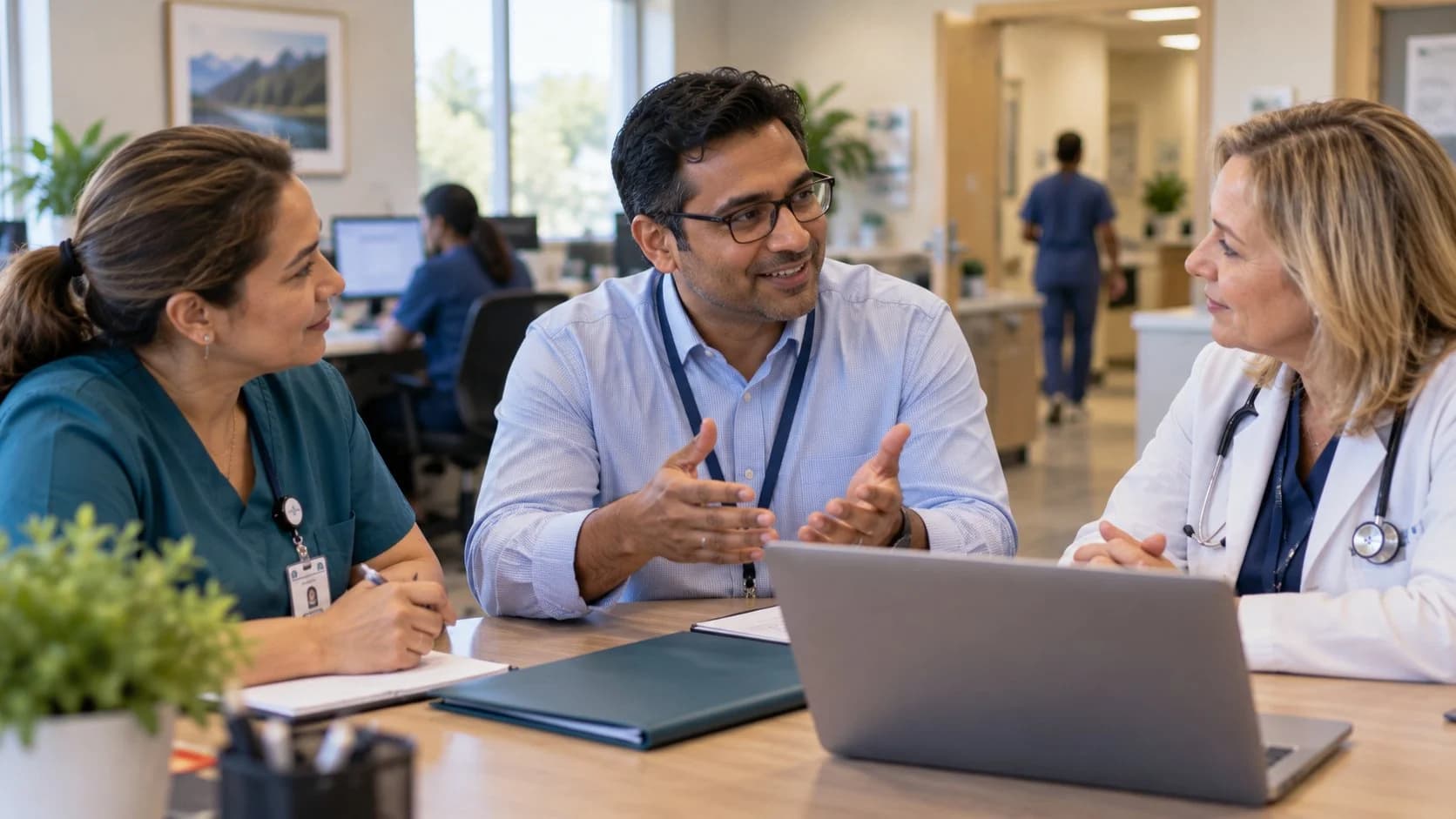Revenue-cycle educator discussing a workflow with medical-office colleagues