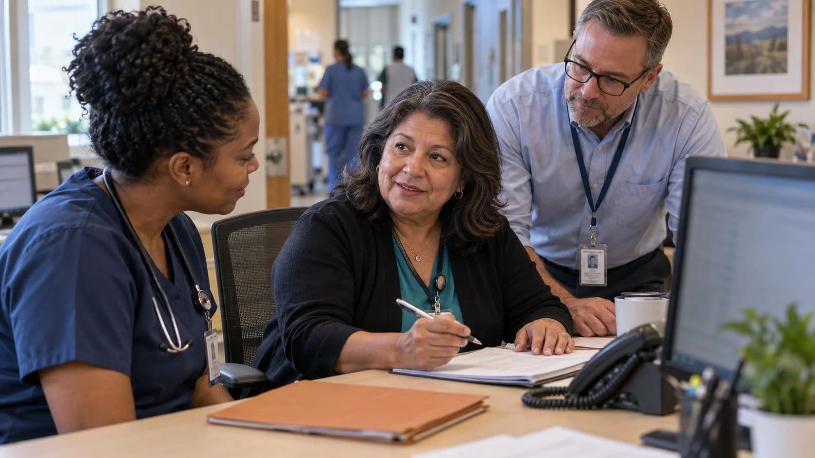 Denial-resolution specialist and clinician reviewing a claim together