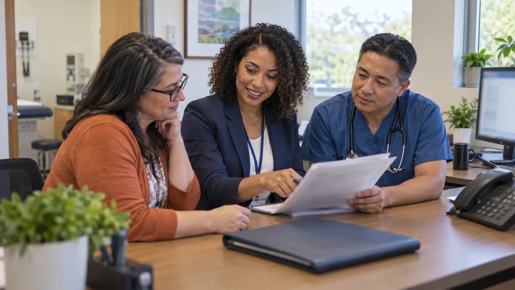Practice manager and clinician reviewing payer requirements with a specialist