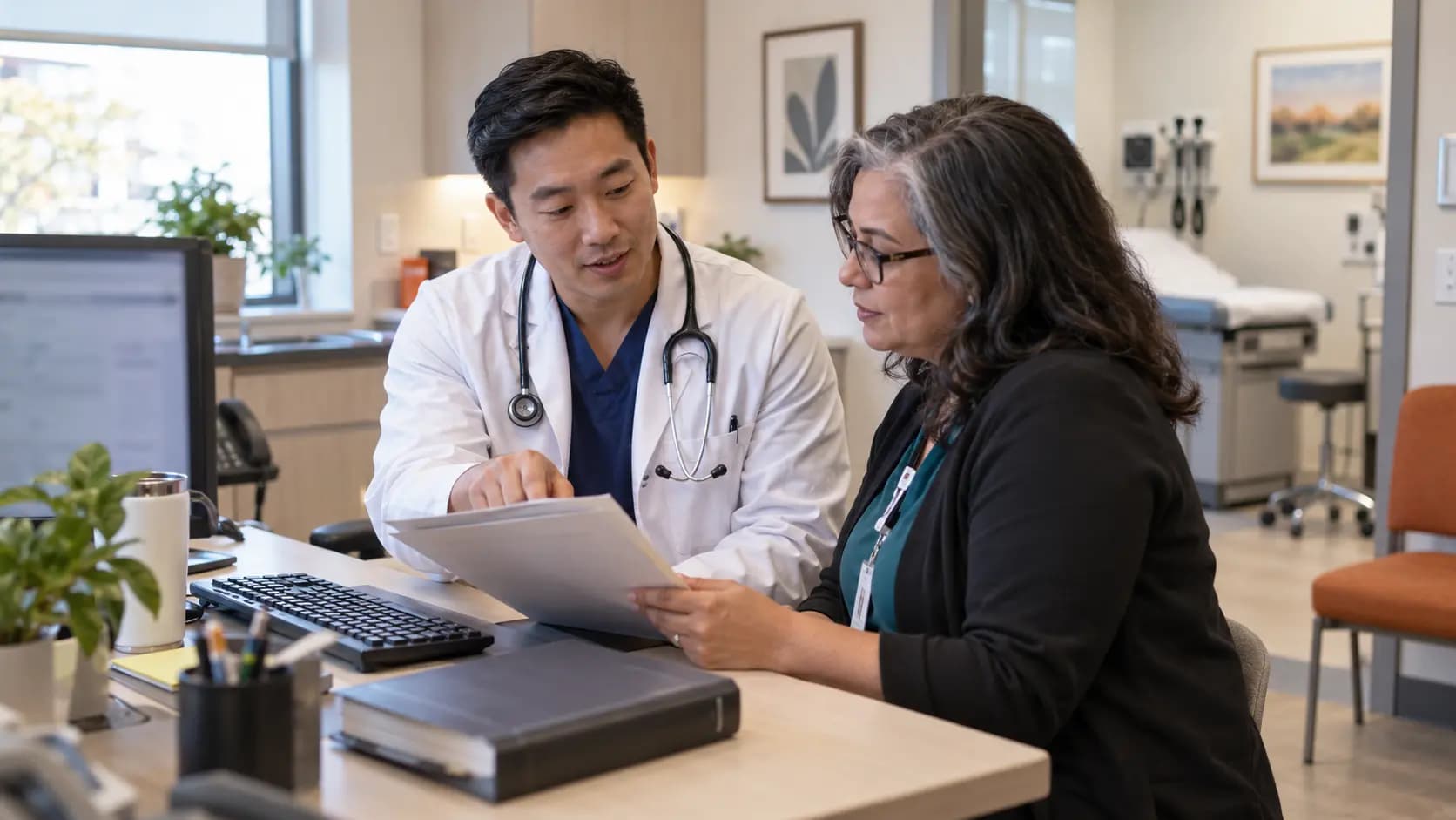 Medical coder and clinician resolving documentation together Medical coder and clinician resolving documentation together
