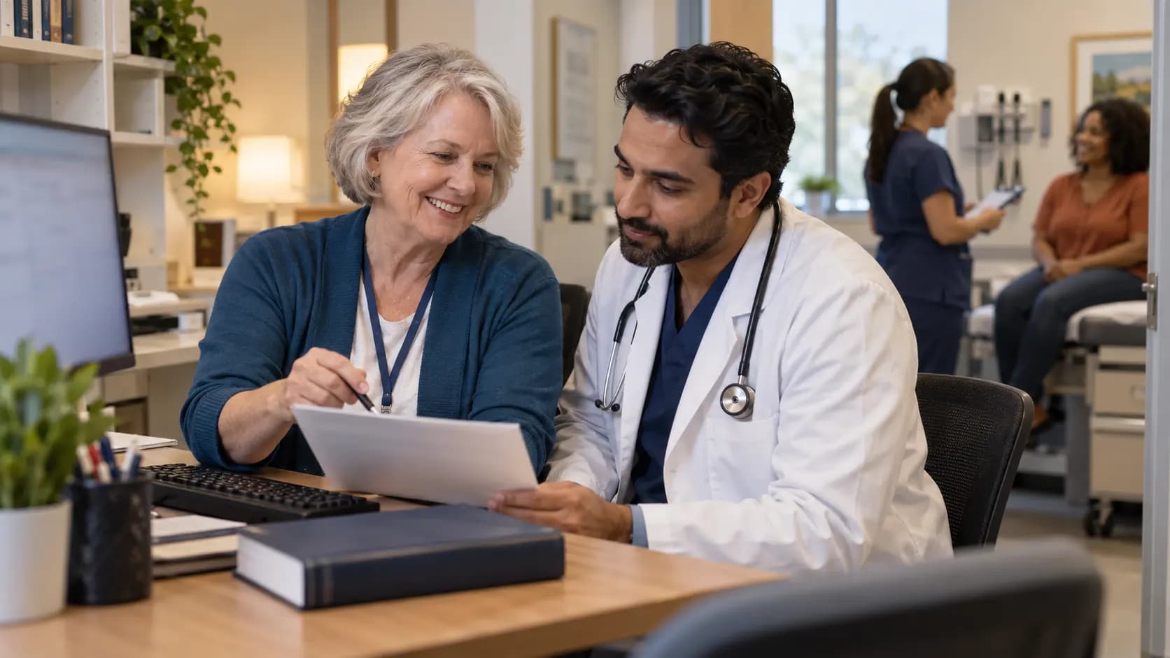 Medical coder and clinician resolving documentation together Medical coder and clinician resolving documentation together