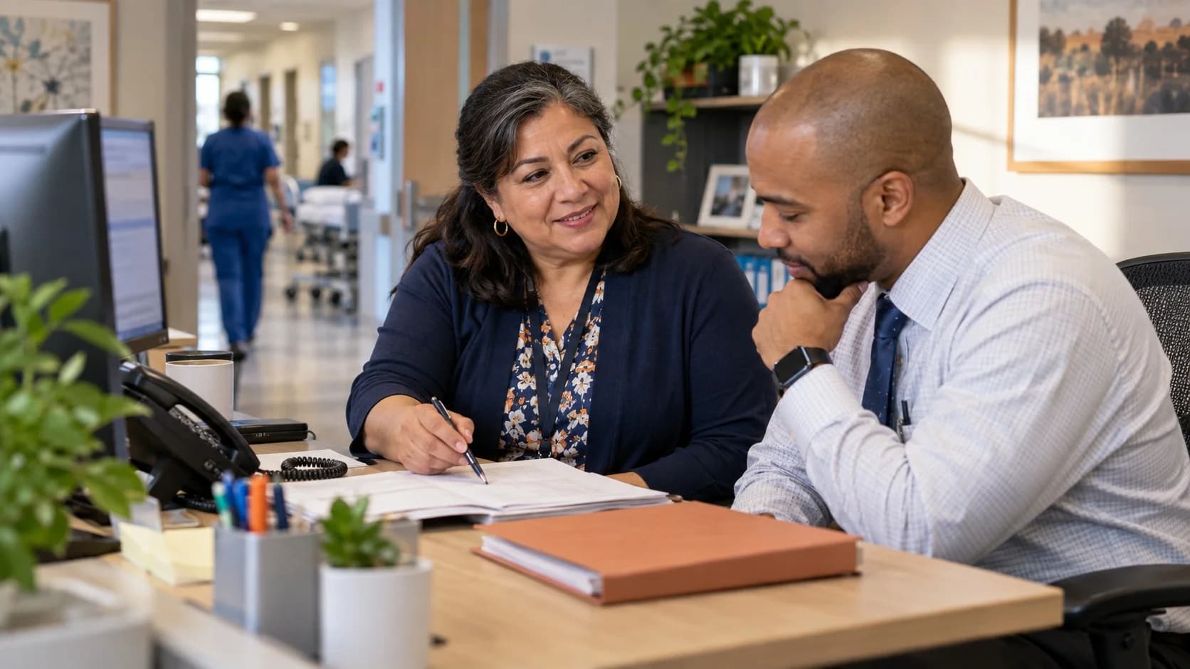 Reimbursement analyst and revenue manager reviewing a payment variance