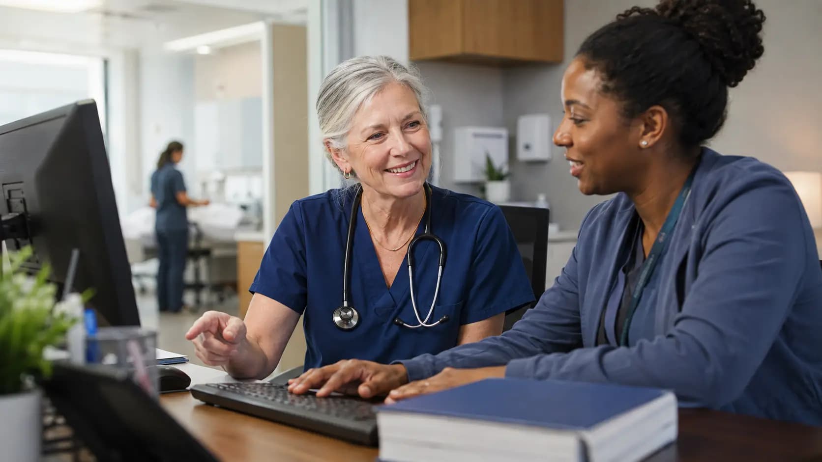 Medical coder and clinician resolving documentation together Medical coder and clinician resolving documentation together