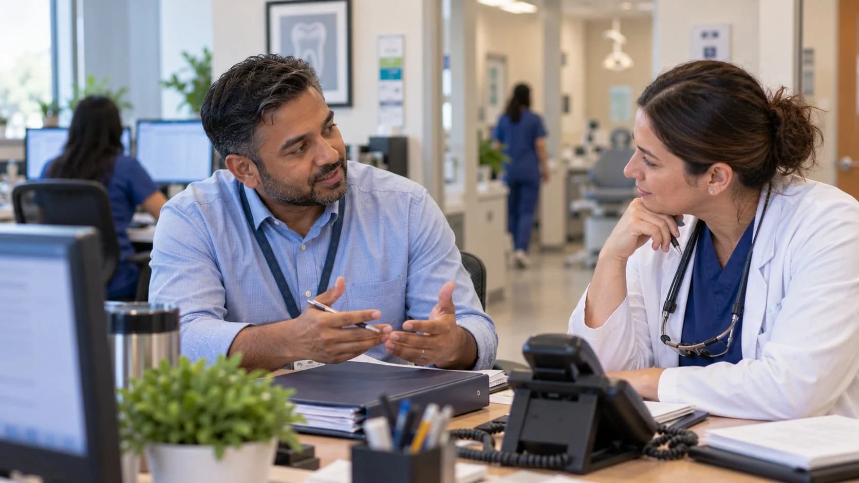 Medical coder and clinician resolving a claim detail together