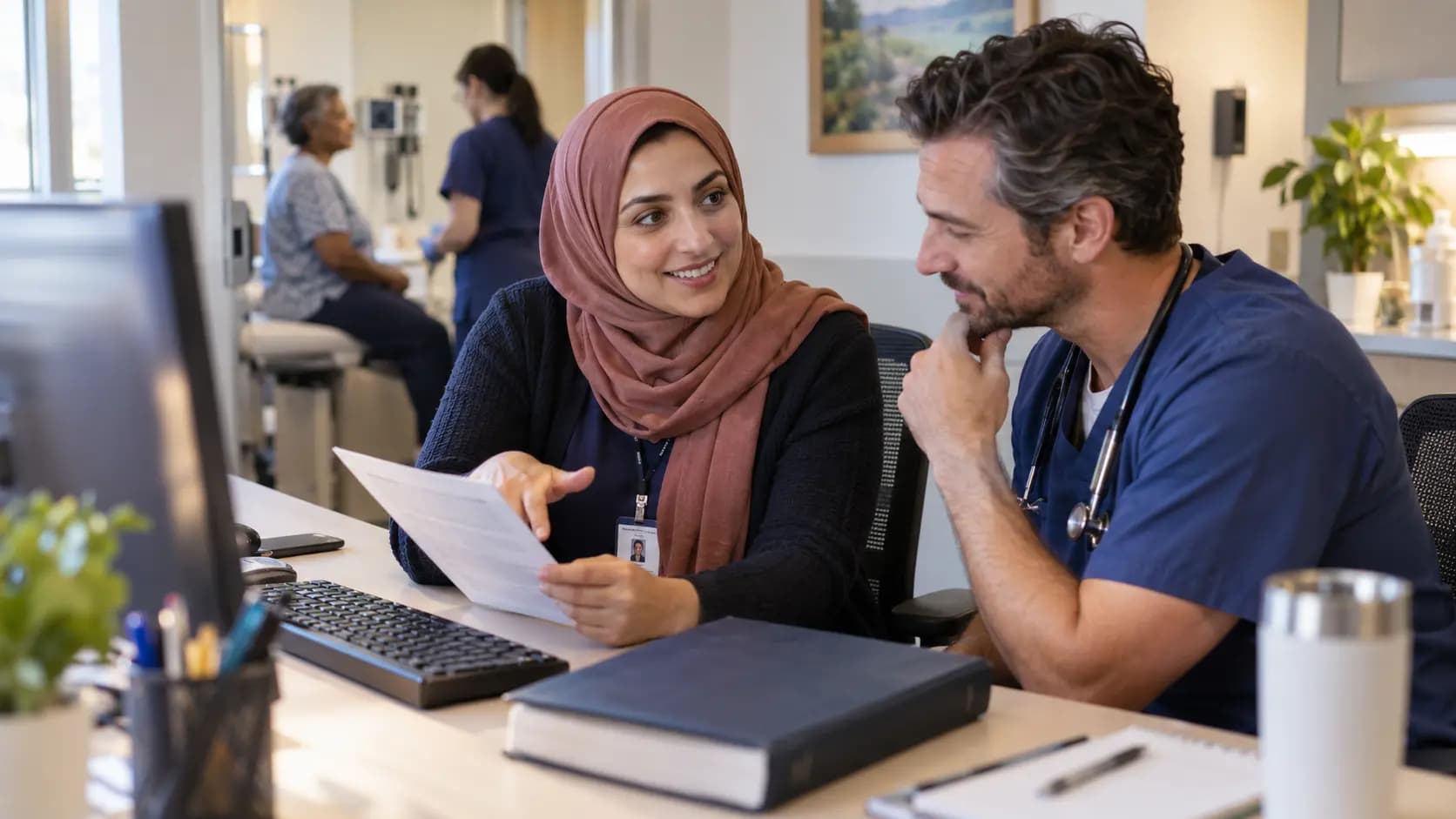 Medical coder and clinician resolving documentation together Medical coder and clinician resolving documentation together