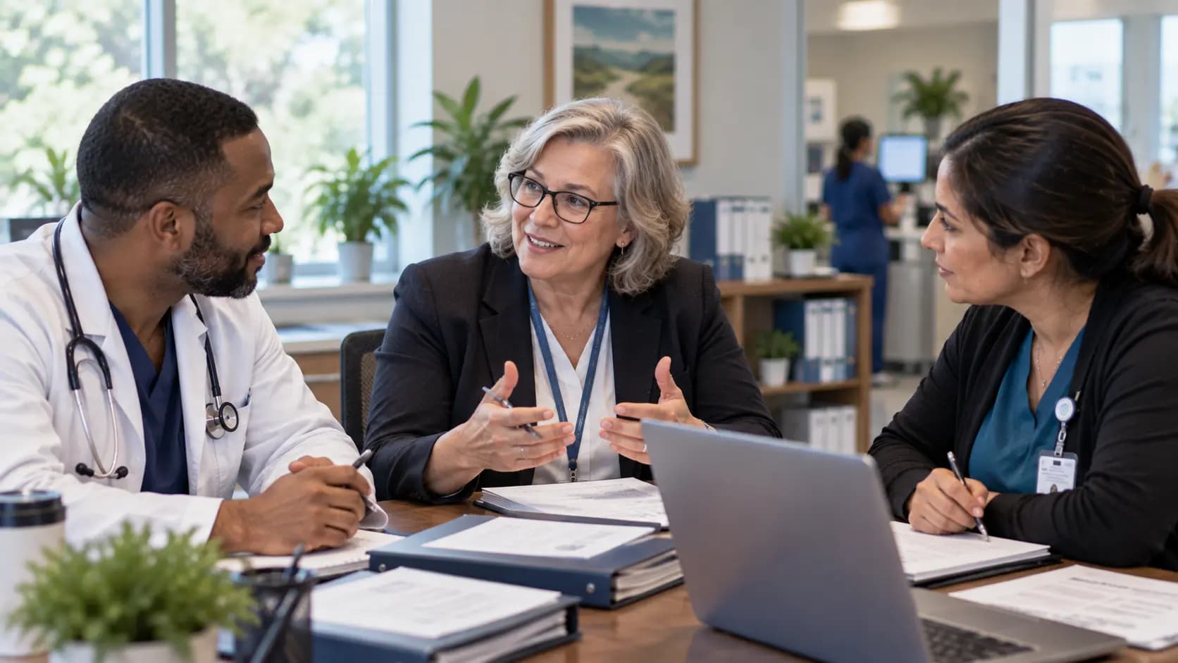 Healthcare compliance officer meeting with a clinician and practice manager Healthcare compliance officer meeting with a clinician and practice manager