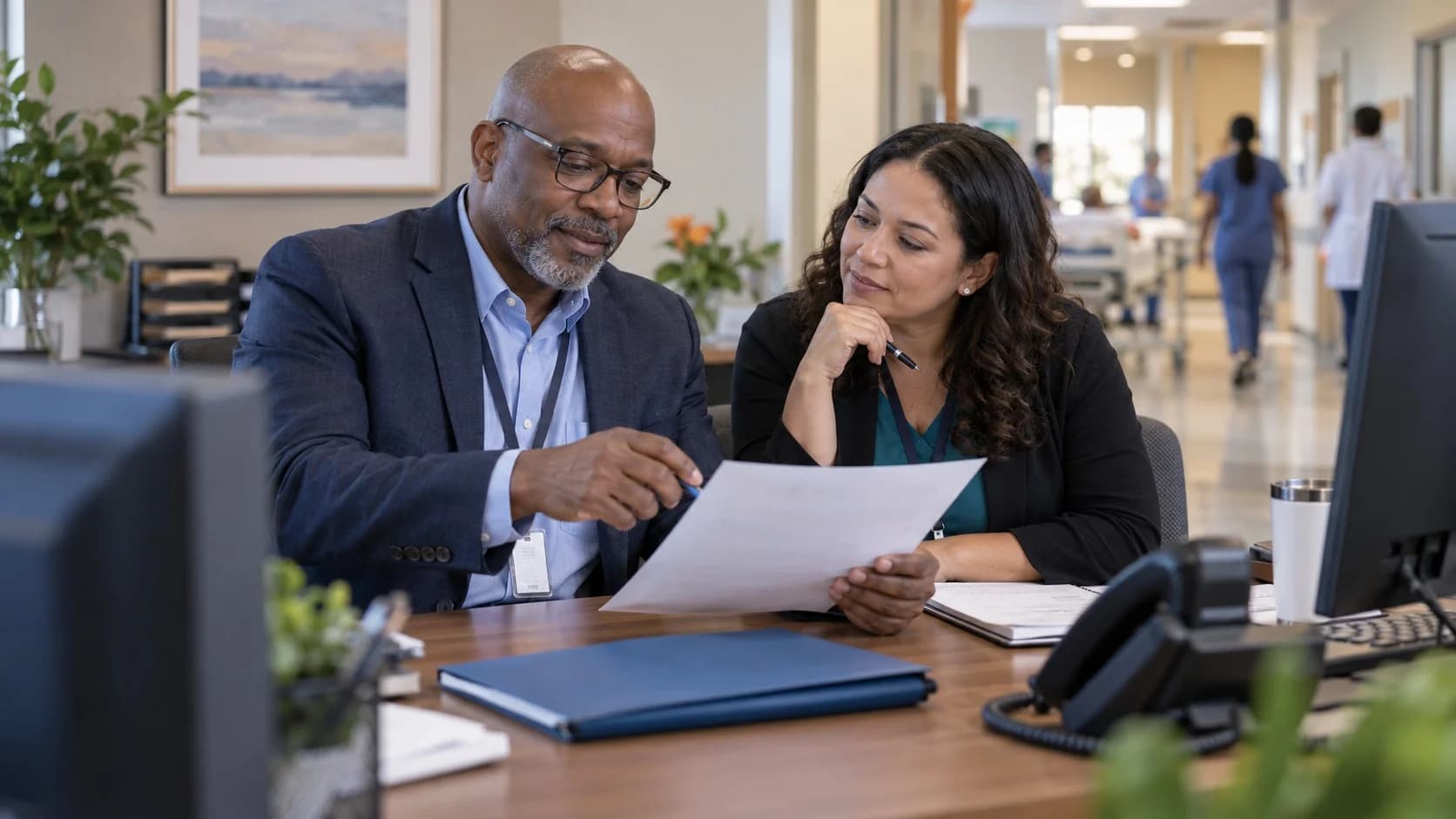 Reimbursement analyst and revenue manager reviewing a payment variance
