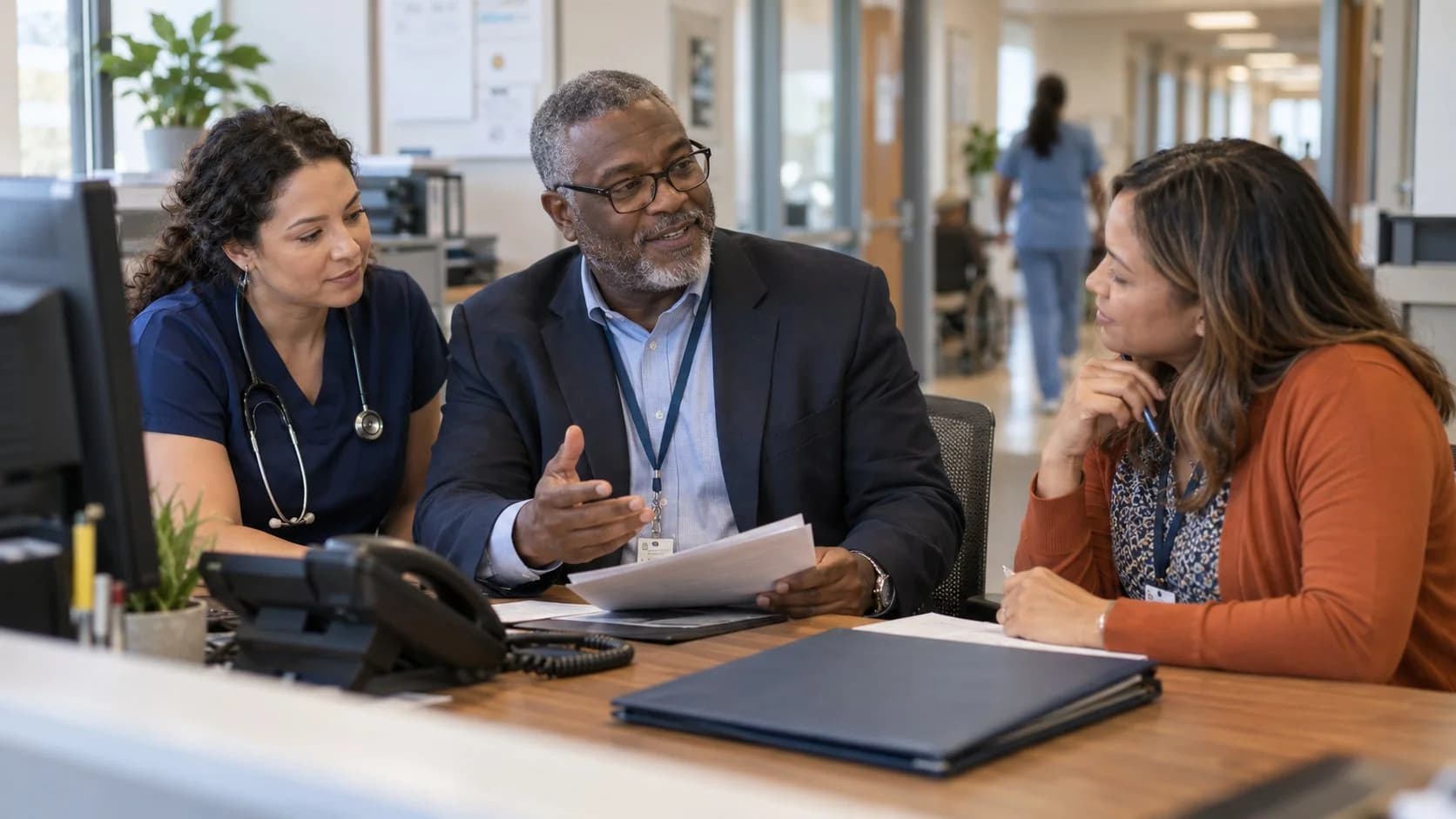 Denial-resolution specialist and clinician reviewing a claim together