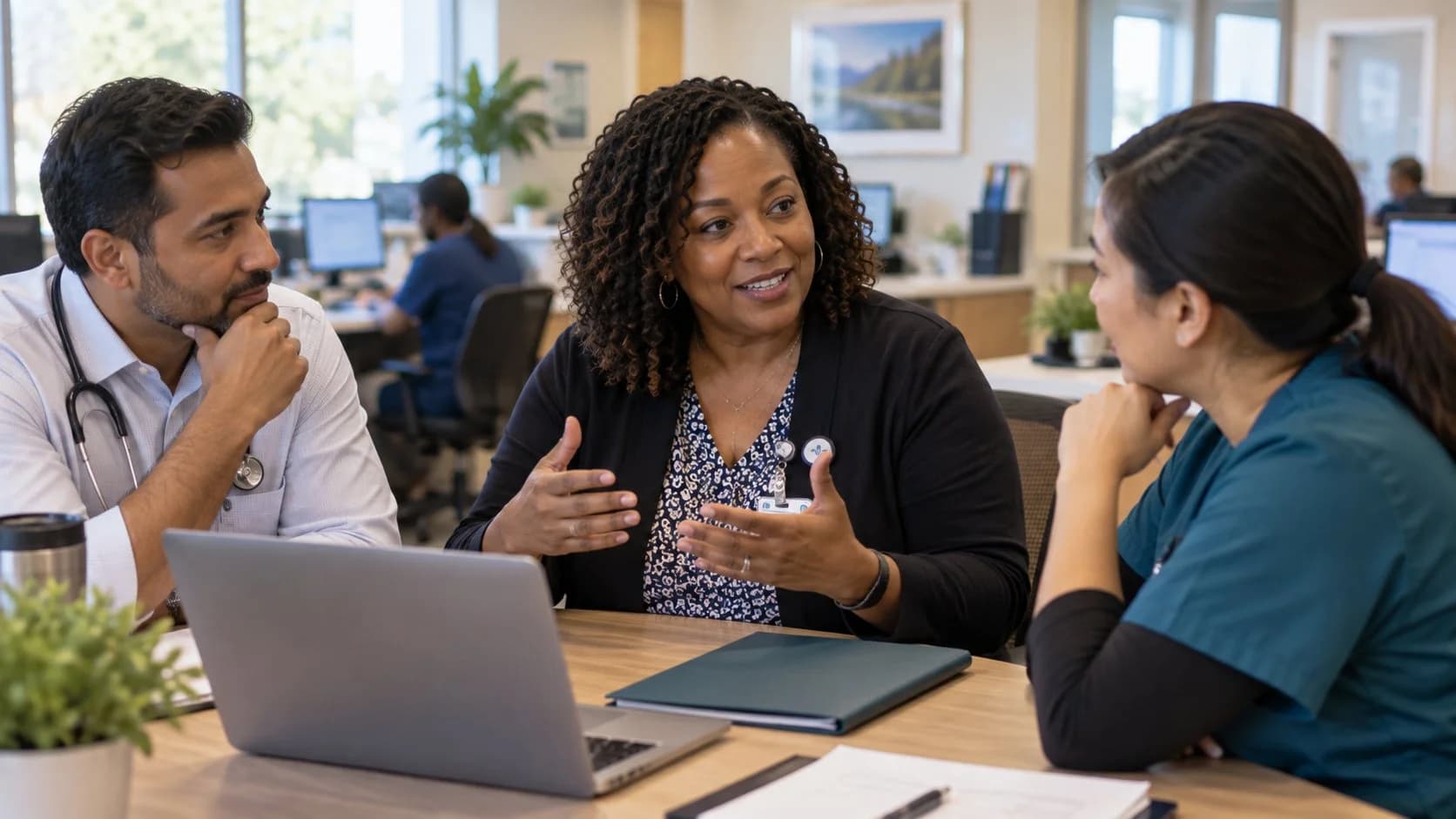 Revenue-cycle educator discussing a workflow with medical-office colleagues