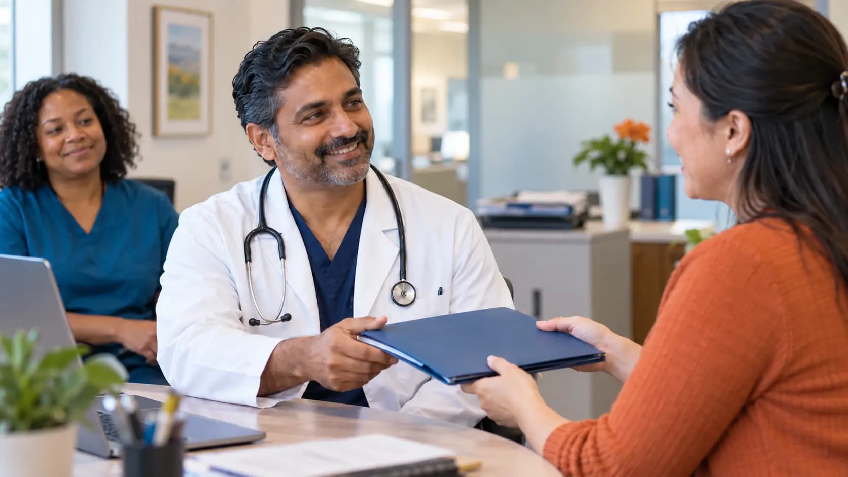 Credentialing coordinator helping a clinician with onboarding