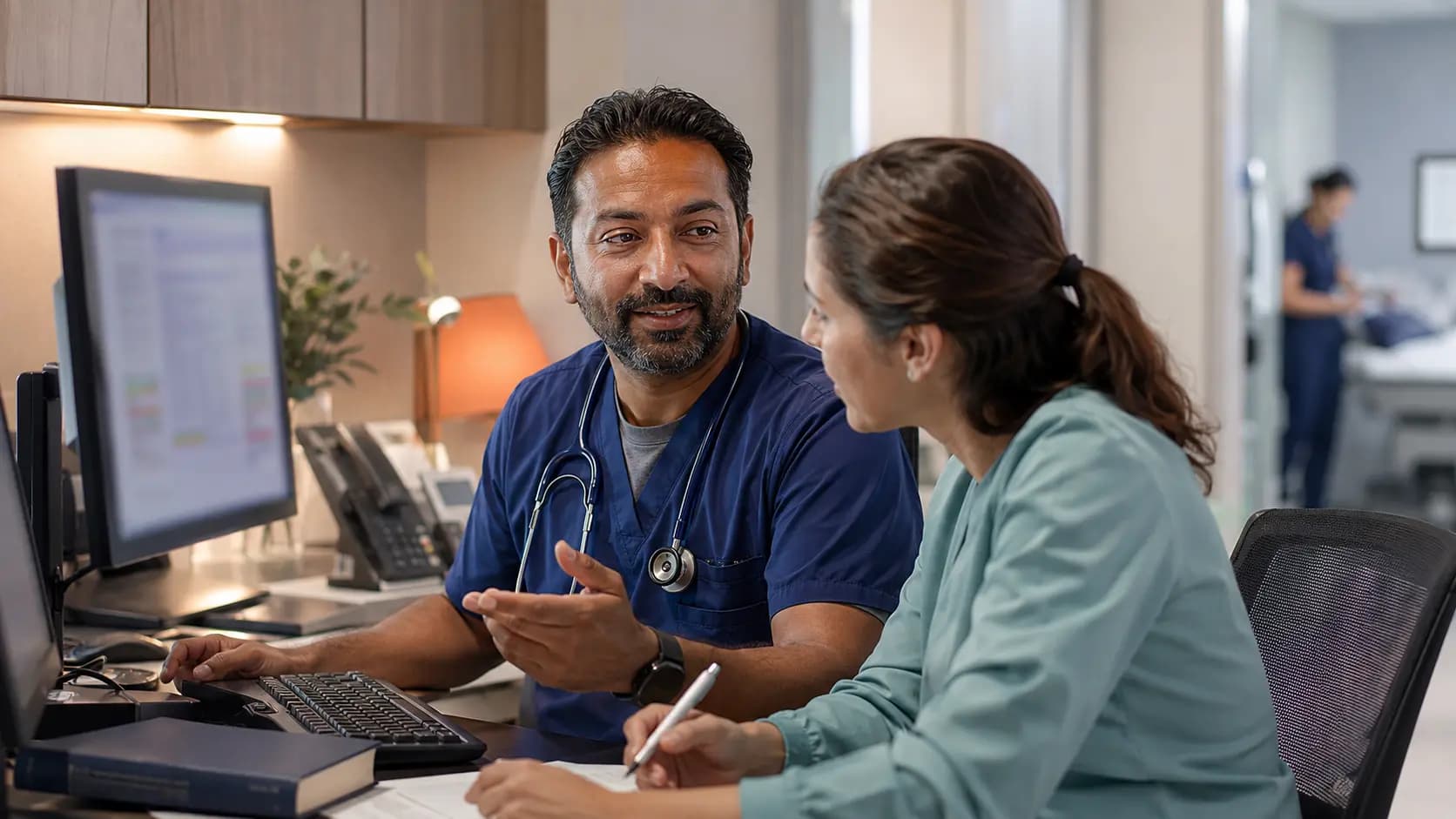 Medical coder and clinician resolving documentation together
