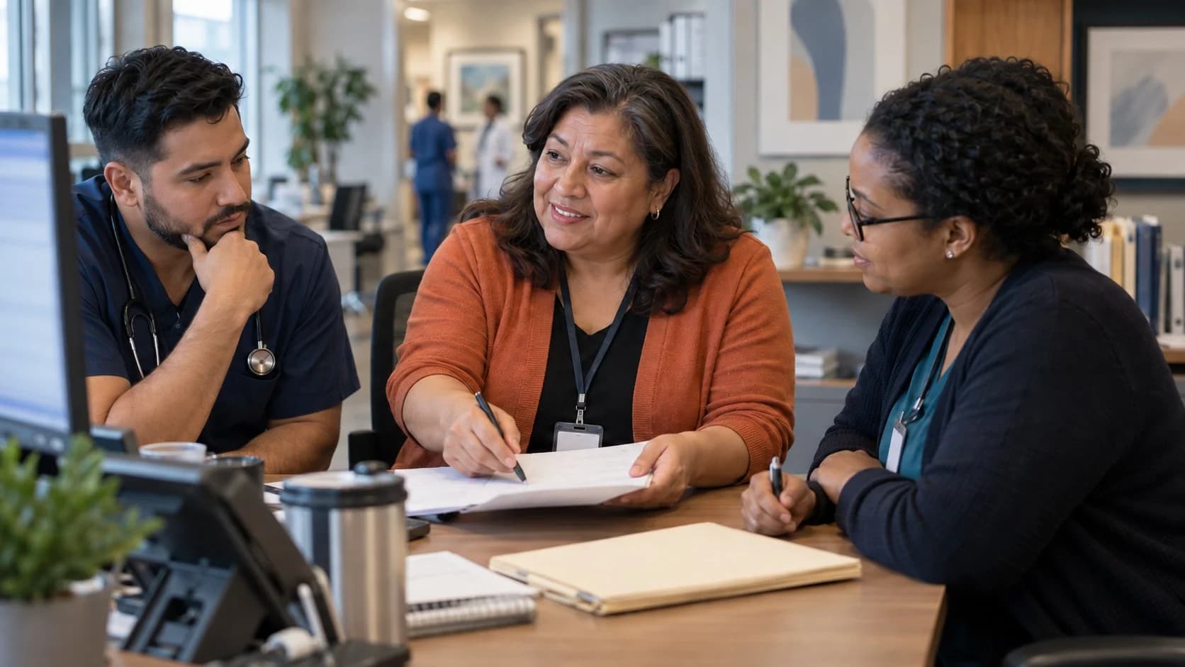 Denial-resolution specialist and clinician reviewing a claim together