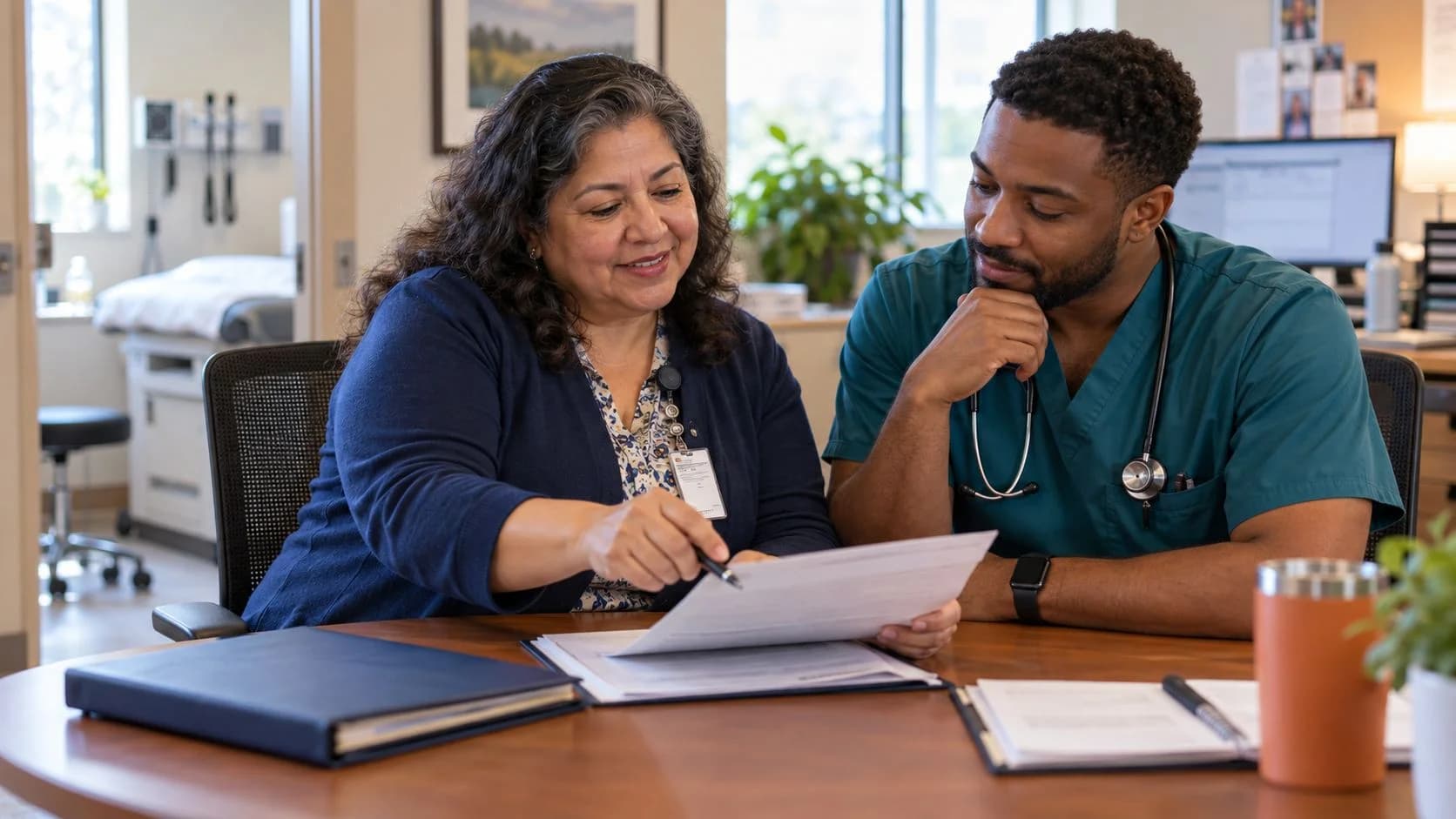 Medical coder and clinician discussing documentation in a medical office
