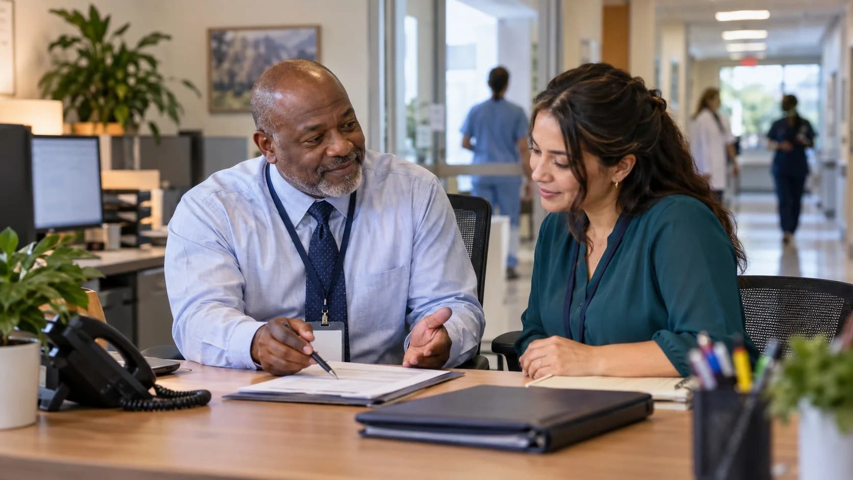 Reimbursement analyst and revenue manager reviewing a payment variance