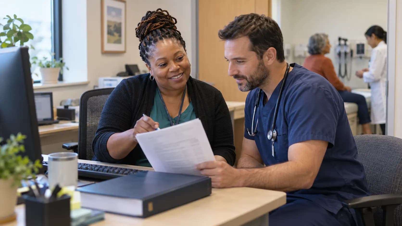 Medical coder and clinician resolving documentation together Medical coder and clinician resolving documentation together