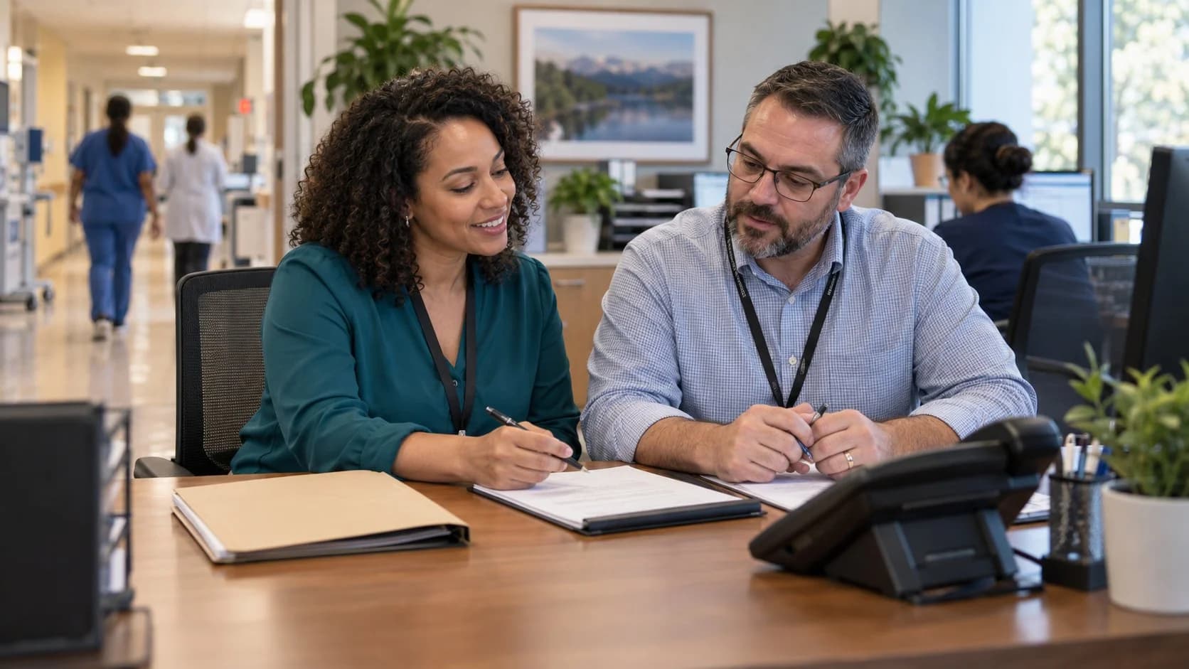 Reimbursement analyst and revenue manager reviewing a payment variance