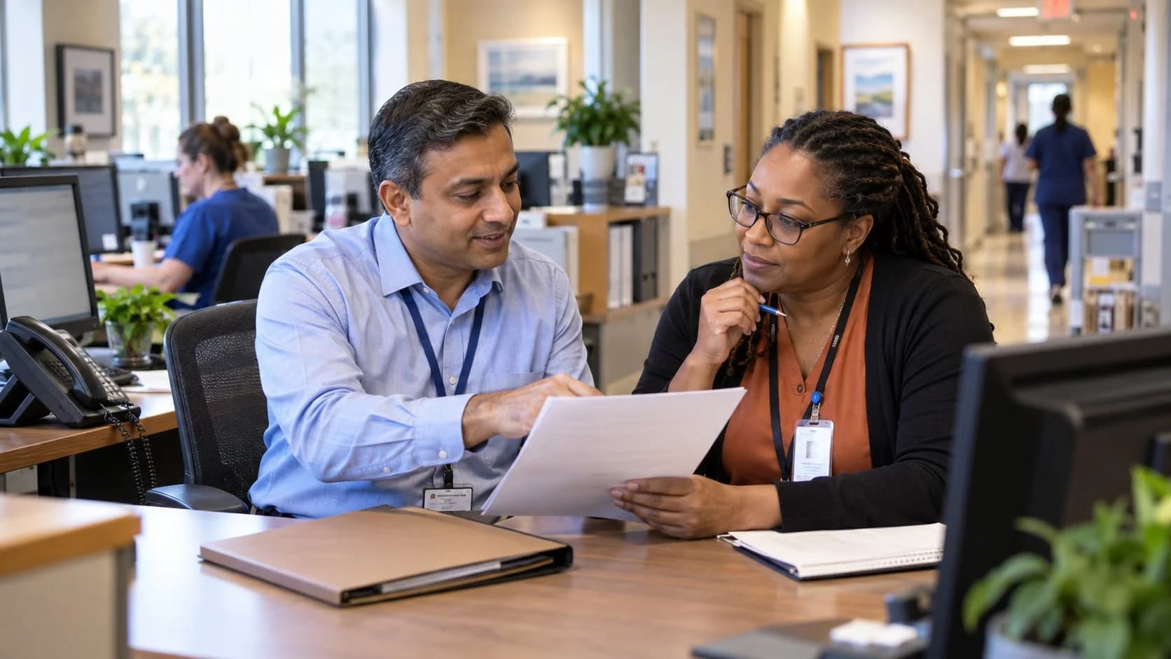Reimbursement analyst and revenue manager reviewing a payment variance