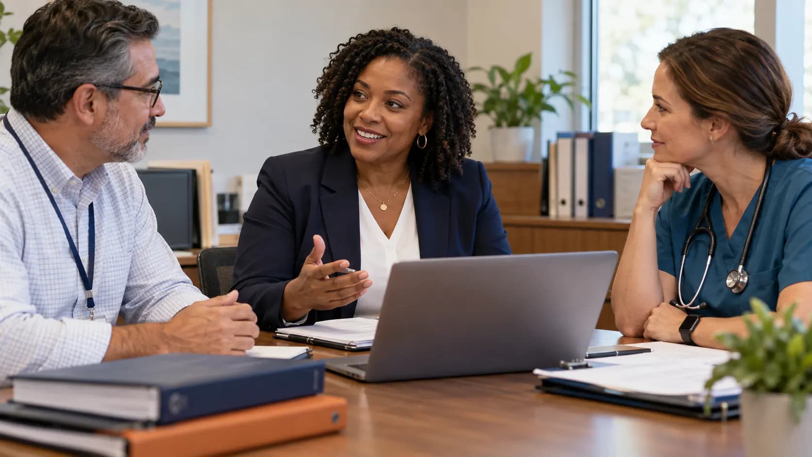 Healthcare compliance officer meeting with a clinician and practice manager Healthcare compliance officer meeting with a clinician and practice manager
