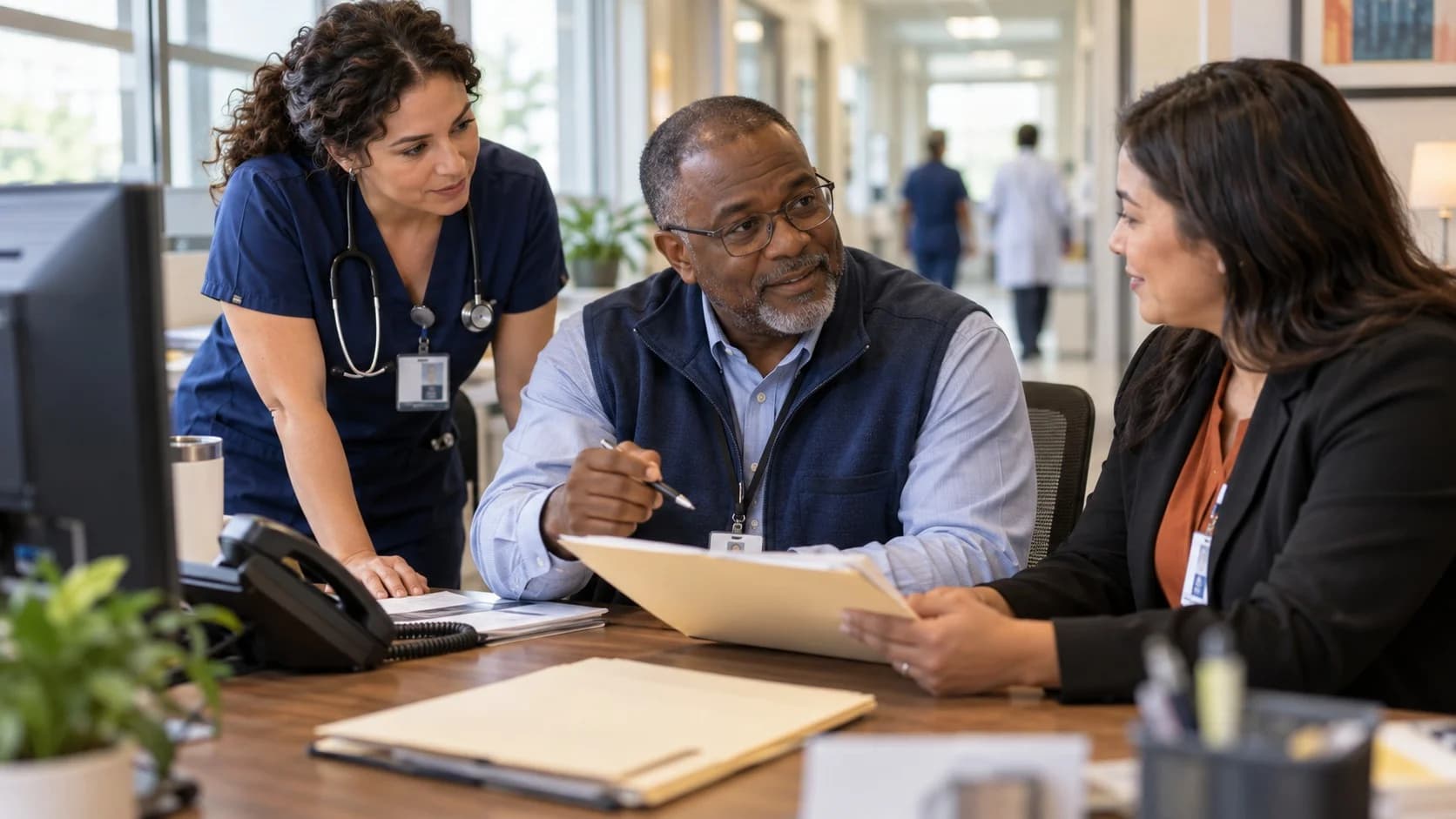 Denial-resolution specialist and clinician reviewing a claim together