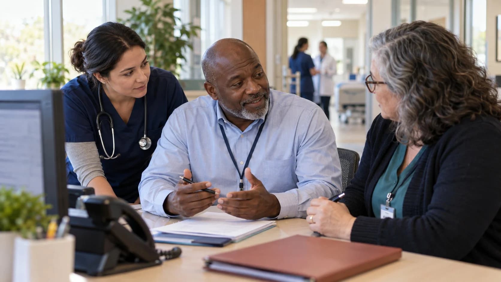 Denial-resolution specialist and clinician reviewing a claim together