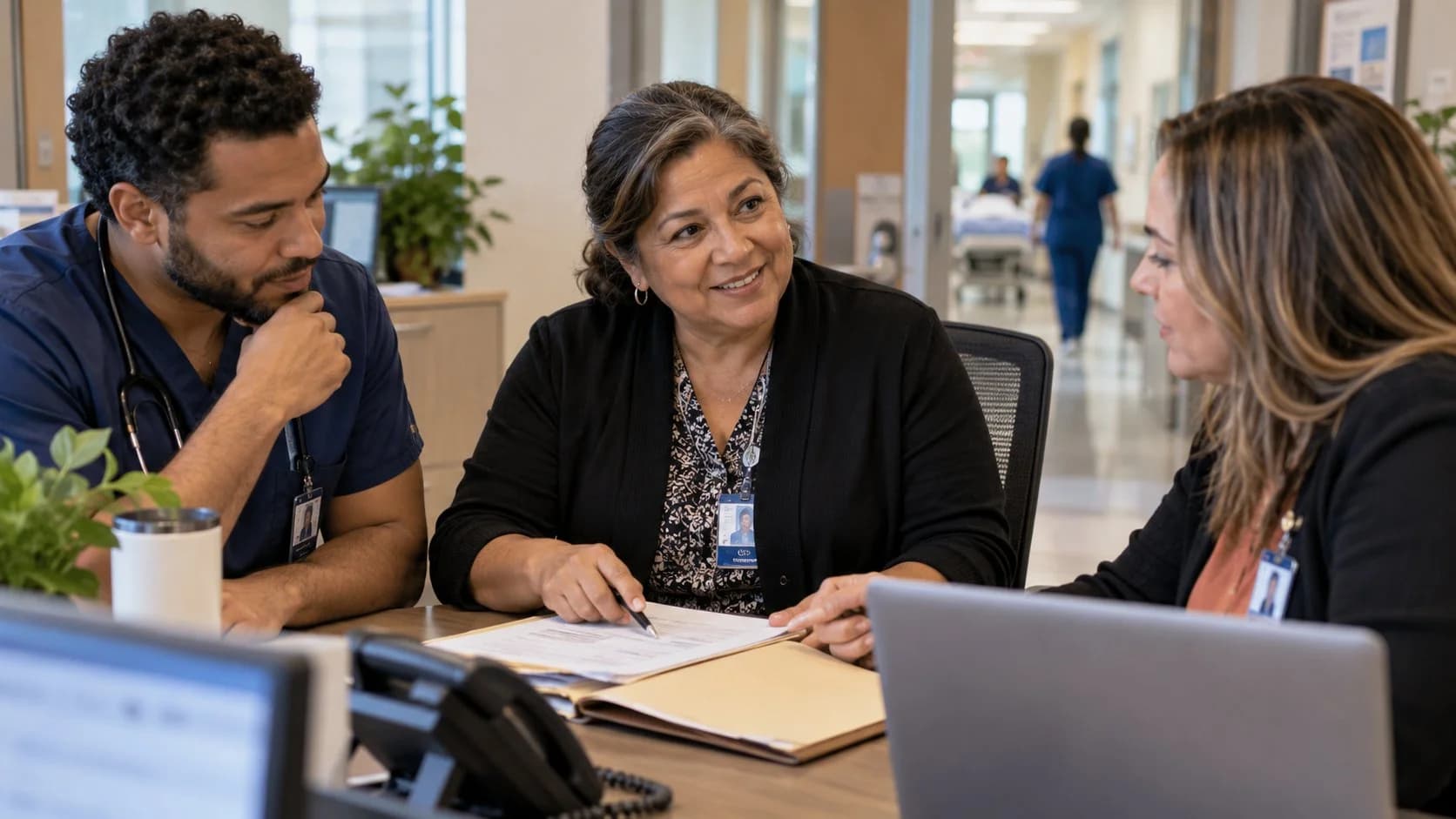 Denial-resolution specialist and clinician reviewing a claim together