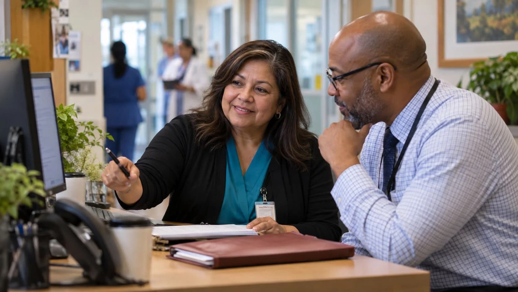 Reimbursement analyst and revenue manager reviewing a payment variance