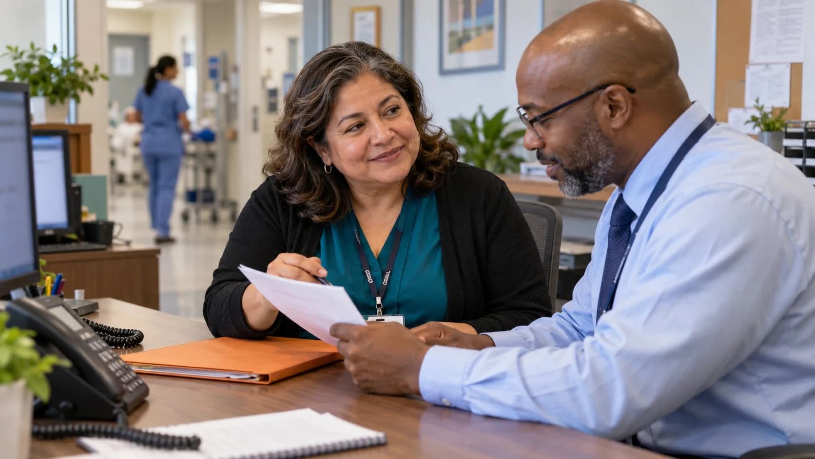 Reimbursement analyst and revenue manager reviewing a payment variance