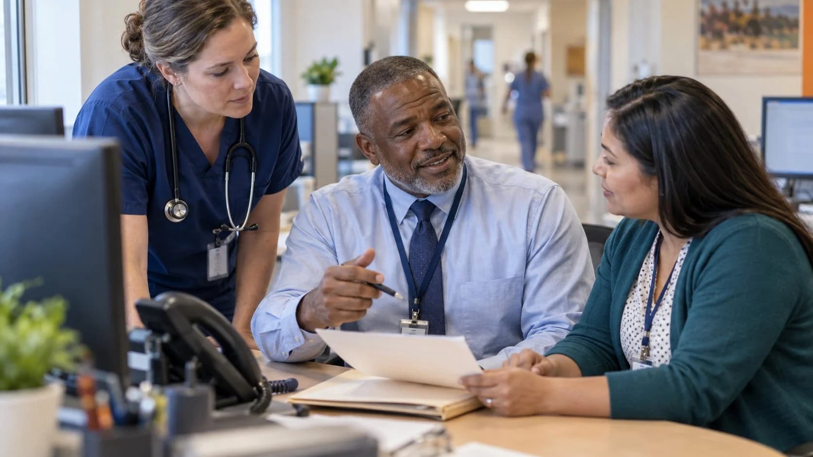 Denial-resolution specialist and clinician reviewing a claim together