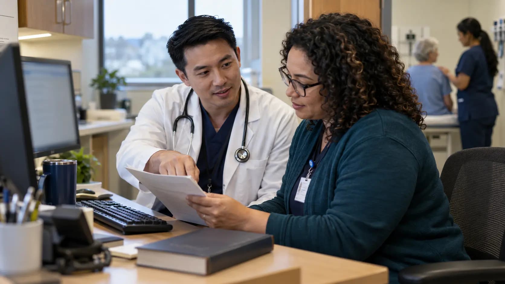 Medical coder and clinician resolving documentation together Medical coder and clinician resolving documentation together