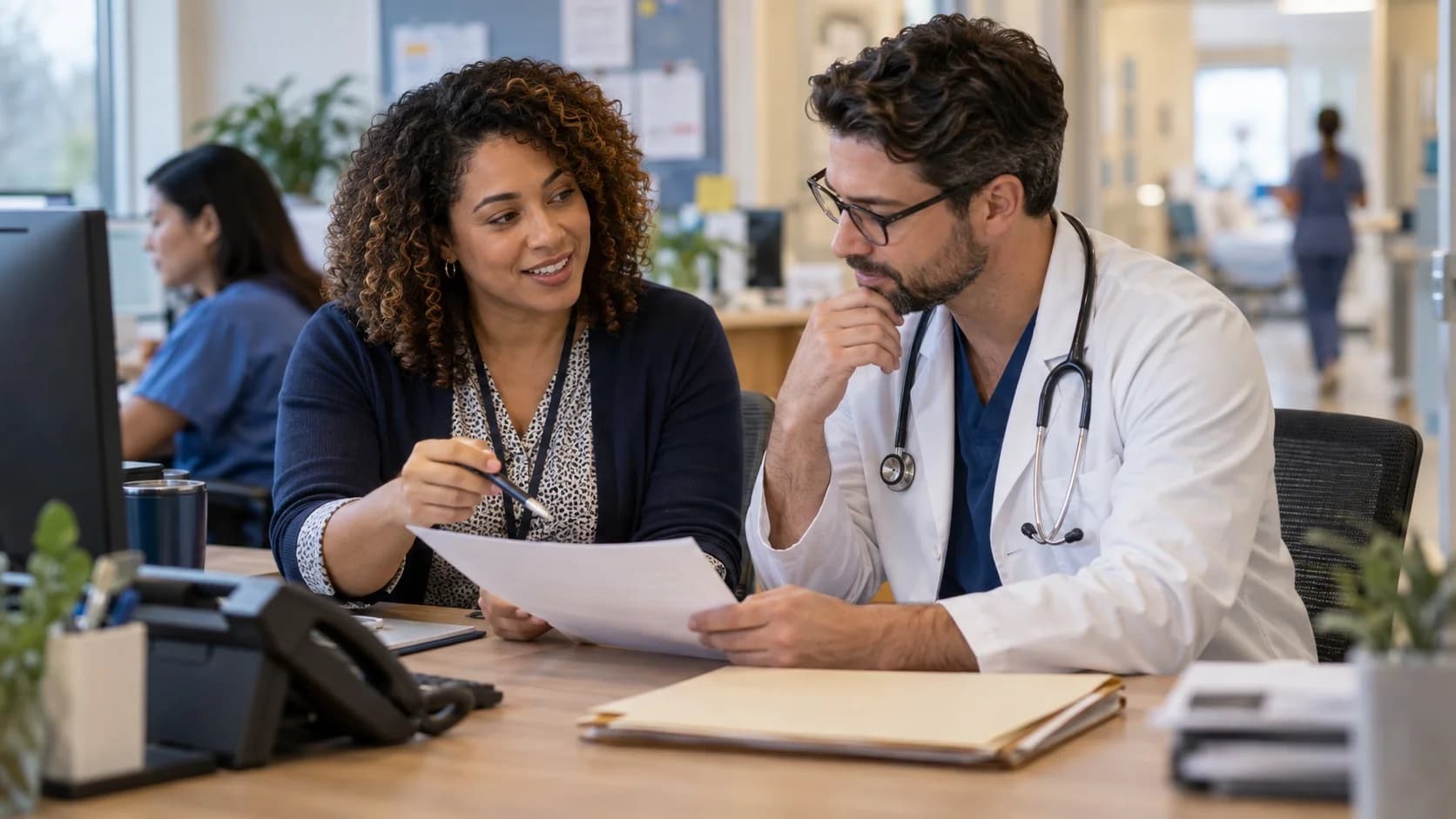 Medical coder and clinician resolving a claim detail together