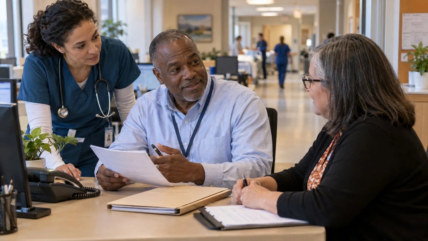 Denial-resolution specialist and clinician reviewing a claim together
