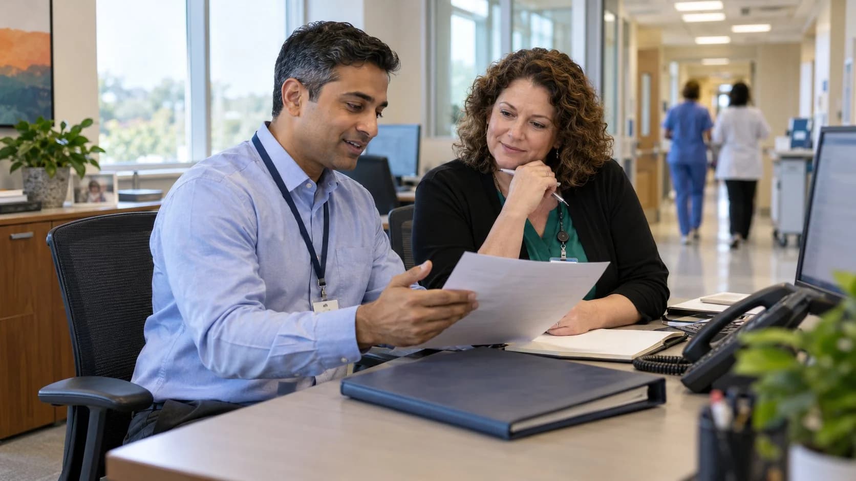 Reimbursement analyst and revenue manager reviewing a payment variance