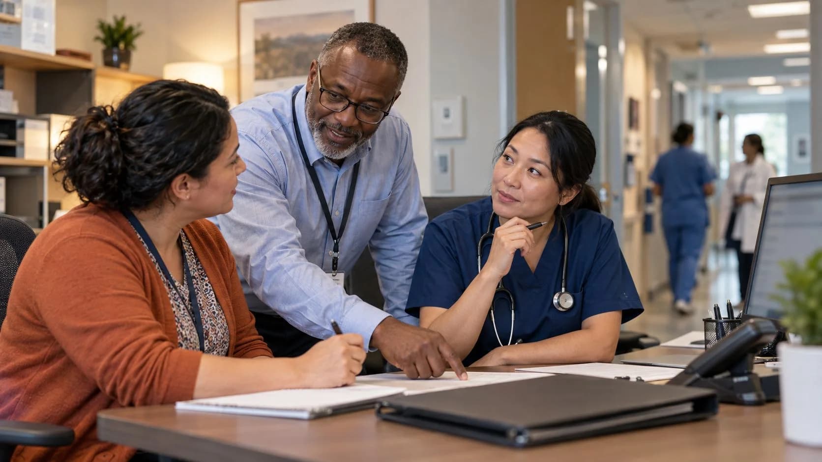 Denial-resolution specialist and clinician reviewing a claim together