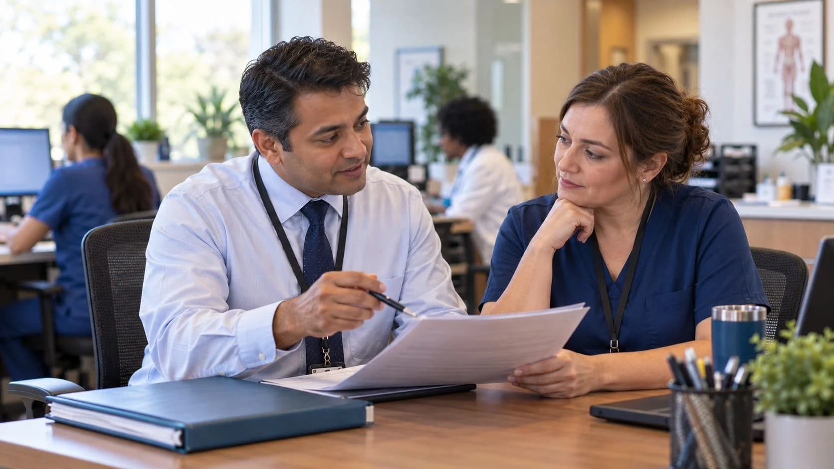 Healthcare compliance officer reviewing a safe workflow with clinic staff