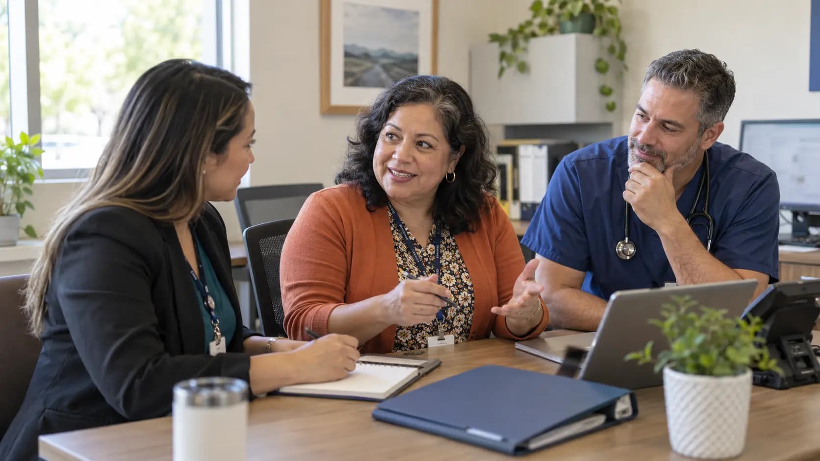 Practice manager and clinician reviewing payer requirements with a specialist
