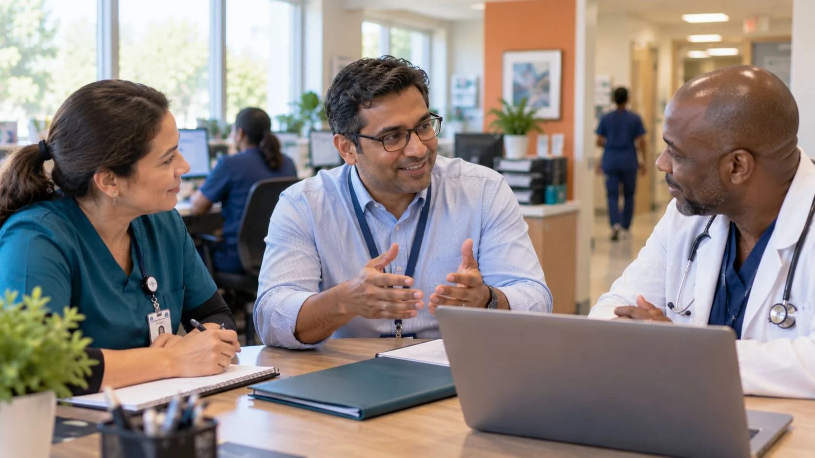 Revenue-cycle educator discussing a workflow with medical-office colleagues
