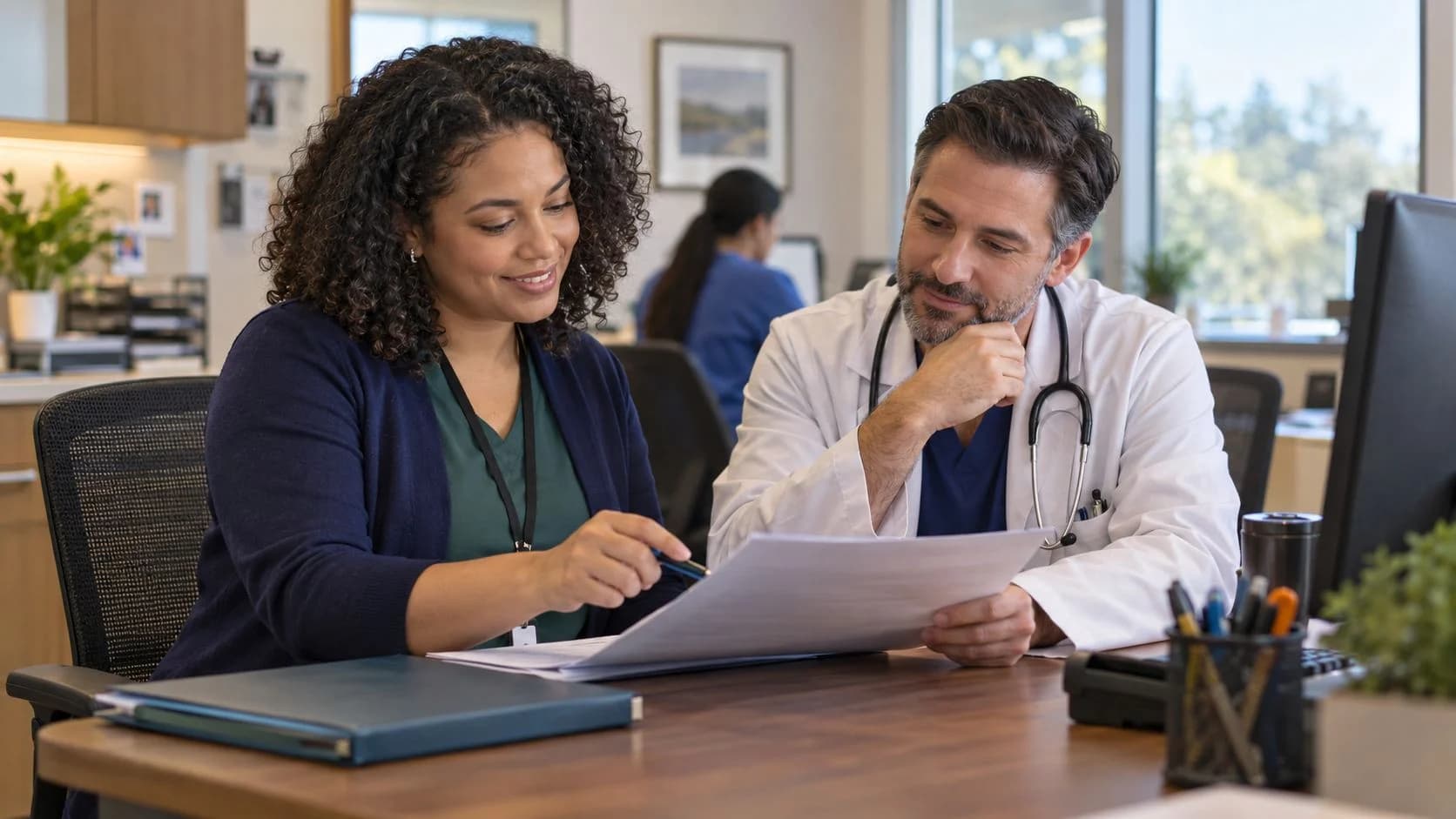 Medical coder and clinician discussing documentation in a medical office