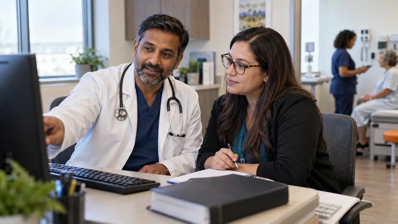 Medical coder and clinician resolving documentation together Medical coder and clinician resolving documentation together