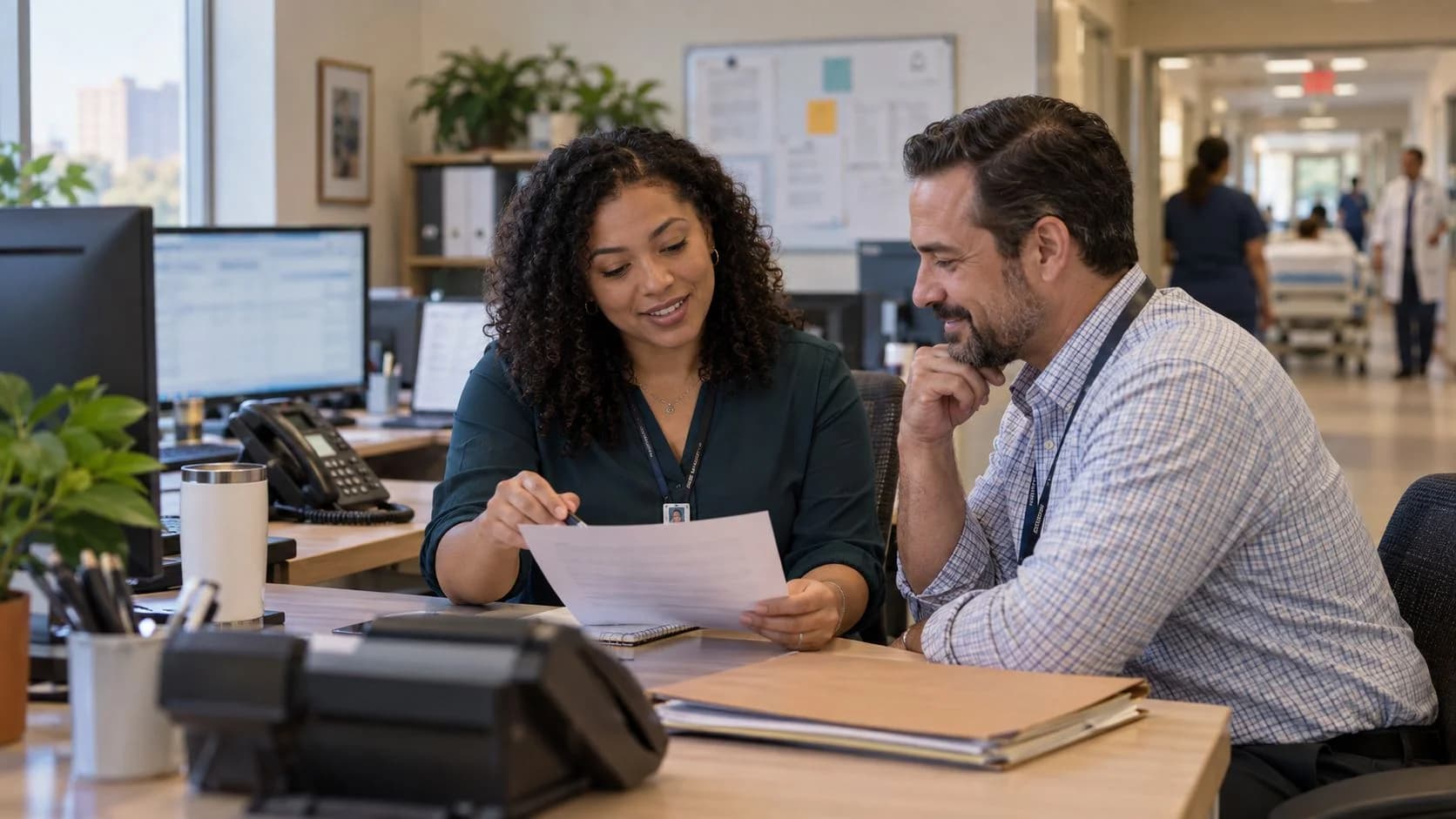 Reimbursement analyst and revenue manager reviewing a payment variance