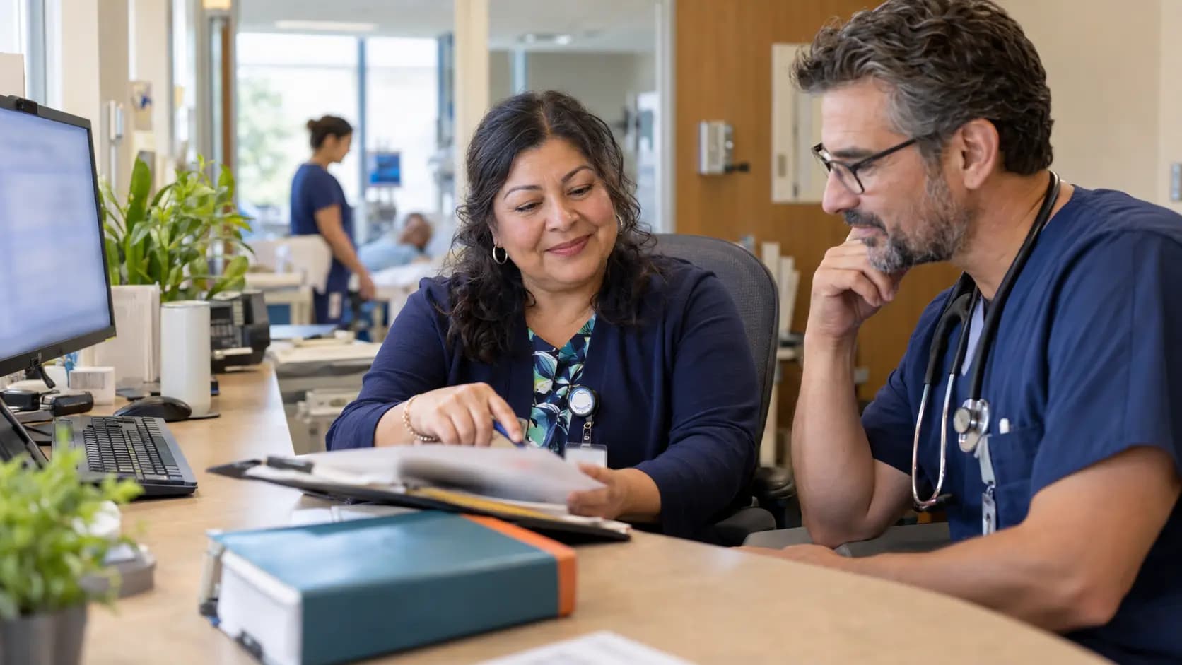 Medical coder and clinician resolving documentation together Medical coder and clinician resolving documentation together