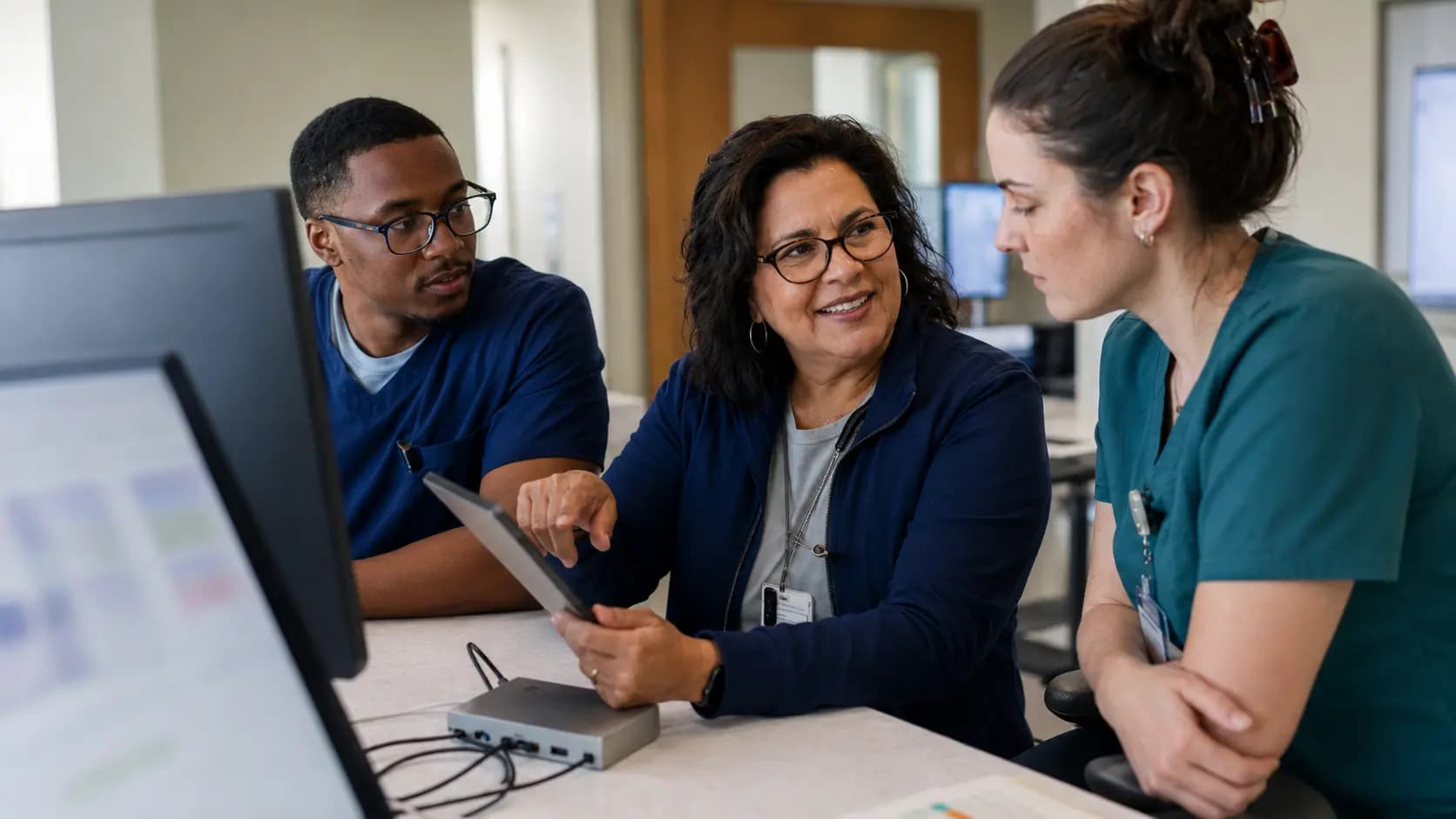 Clinician and informatics specialists collaborating at a normal workstation