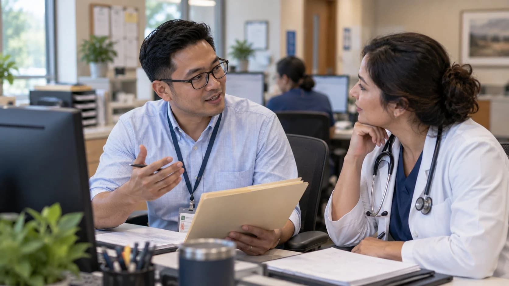 Denial specialist and clinician reviewing a claim workflow together