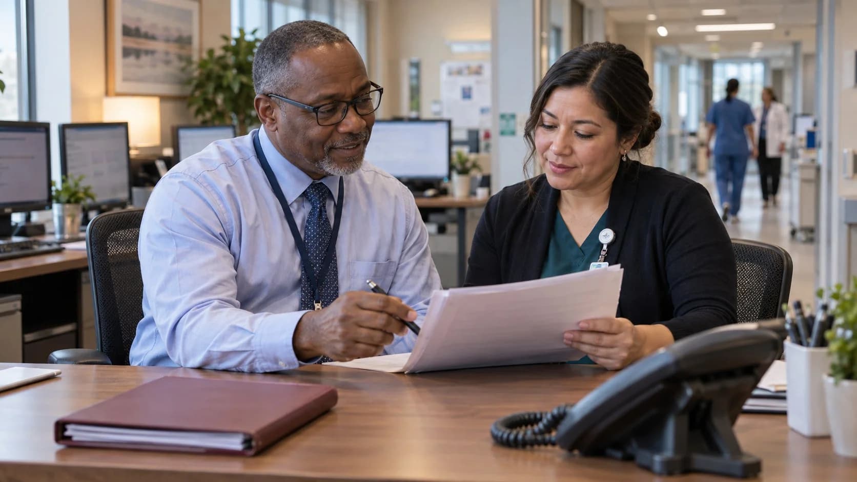 Reimbursement analyst and revenue manager reviewing a payment variance